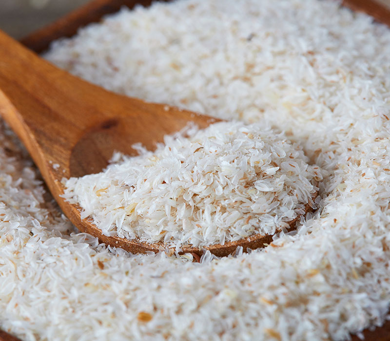 Close-up of grated coconut on a wooden spoon.