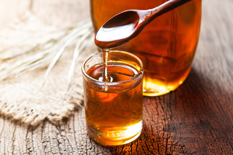 Brown rice syrup in a glass container