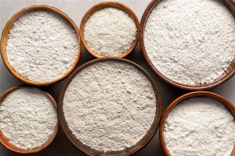 a top-down image of bowls containing of different kinds of flour