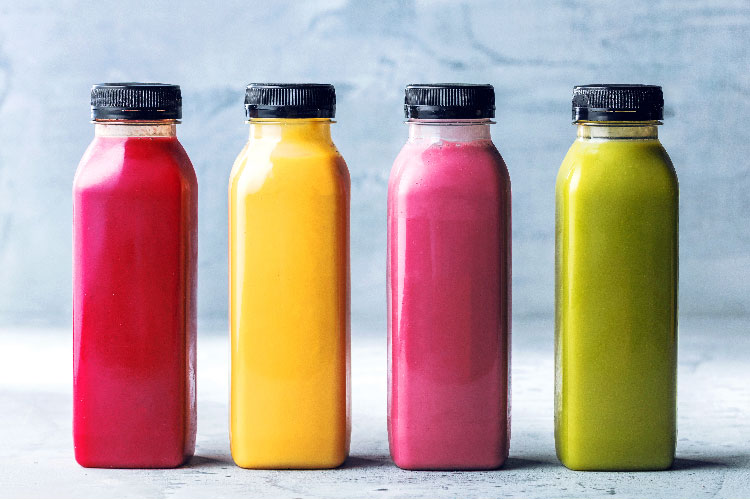 A collection of different blended fruit smoothies in a container